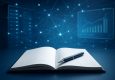 Open notebook with a pen on a tech-inspired background