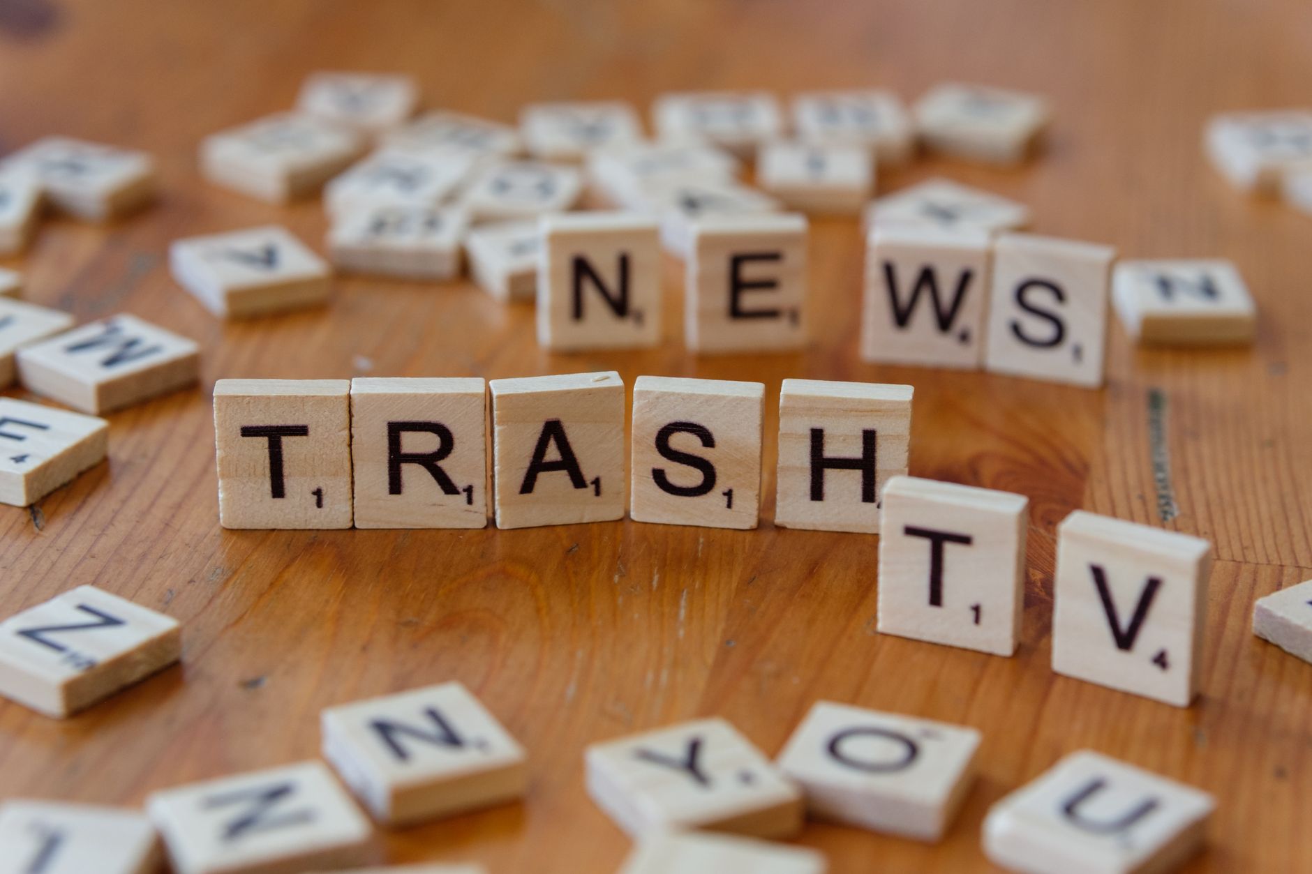 Close-up of wooden letter tiles spelling out Trash TV News on a table. — Intimate Leisure In Odessa - Why Misodessa Is Best S