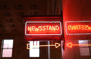 Bright neon newsstand sign reflecting on wall in urban environment. — Mastering SEO Strategies: Your 2022 Comprehensive Guide